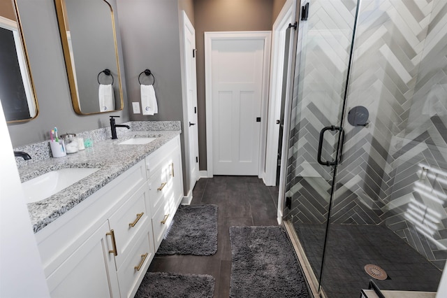 bathroom with wood-type flooring, an enclosed shower, and vanity