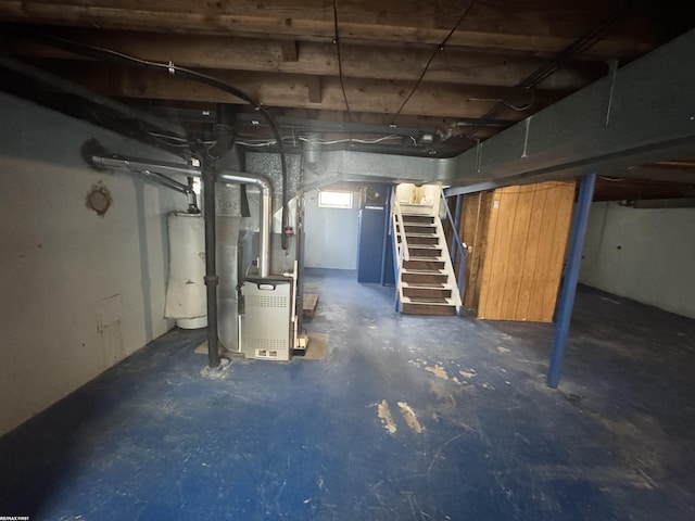 unfinished basement with gas water heater, heating unit, and stairs