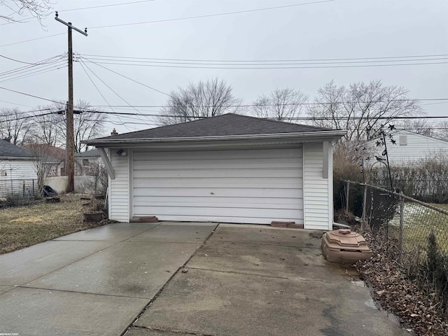 detached garage featuring fence