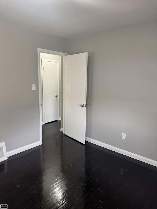 spare room featuring dark hardwood / wood-style flooring