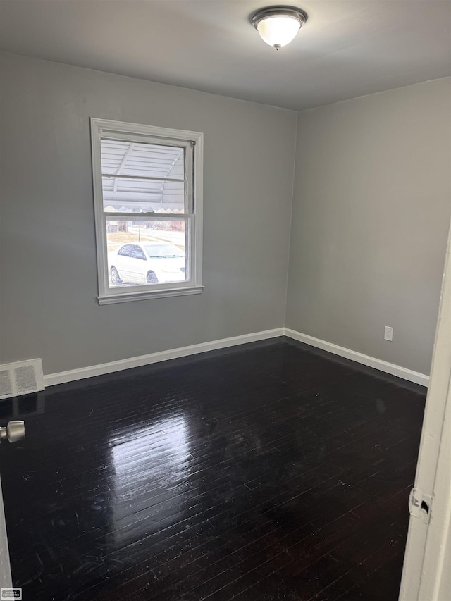 spare room featuring dark hardwood / wood-style floors