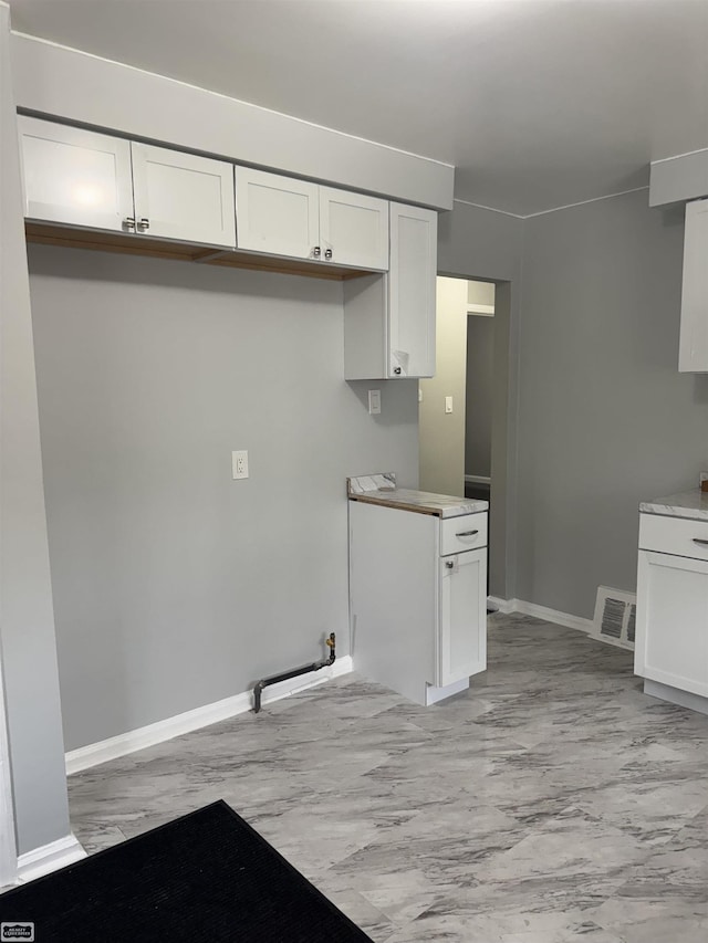 kitchen featuring white cabinets