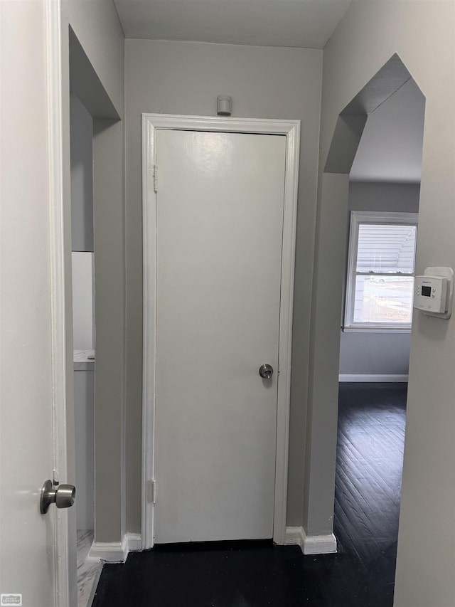 corridor featuring dark hardwood / wood-style floors