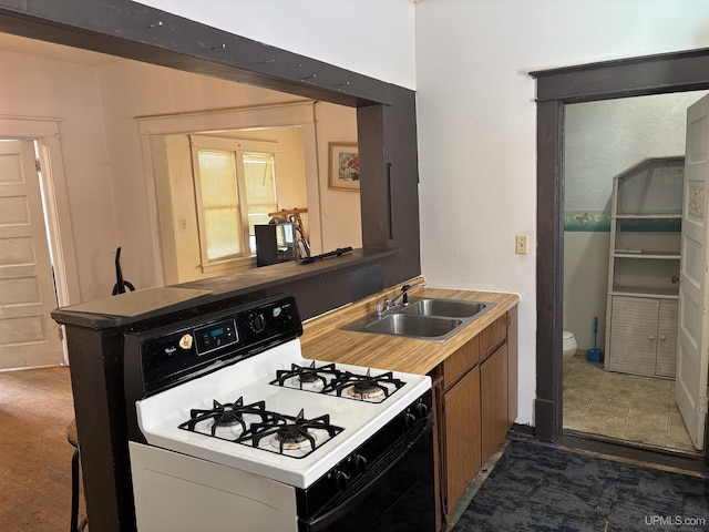 kitchen with white gas range and sink