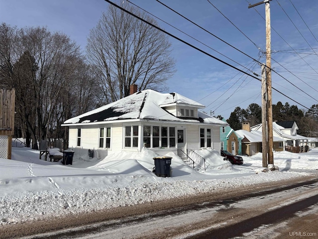 view of snow covered rear of property