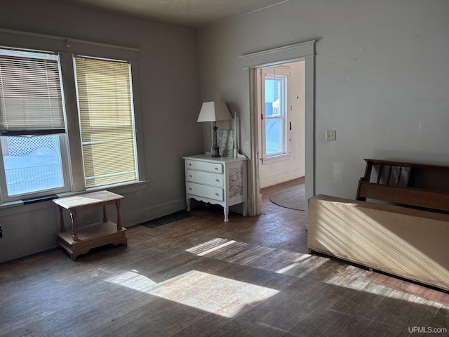 unfurnished bedroom with dark wood-type flooring and a textured ceiling