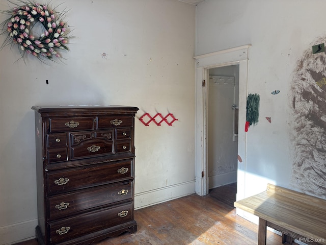 hallway with hardwood / wood-style flooring