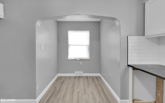 unfurnished dining area featuring light wood-type flooring