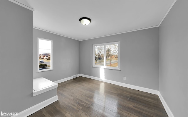 empty room featuring ornamental molding and dark hardwood / wood-style floors