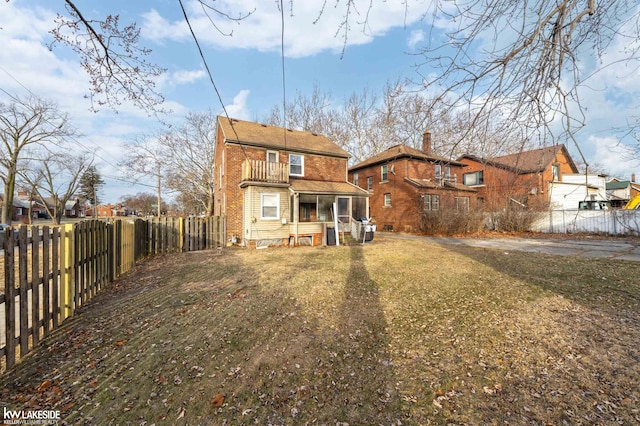 back of property featuring a lawn