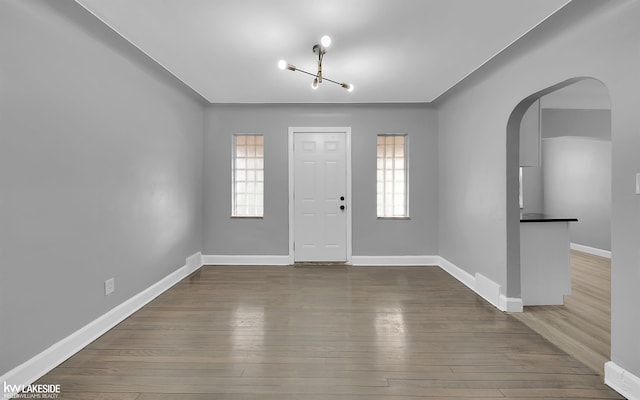 foyer featuring plenty of natural light and hardwood / wood-style floors