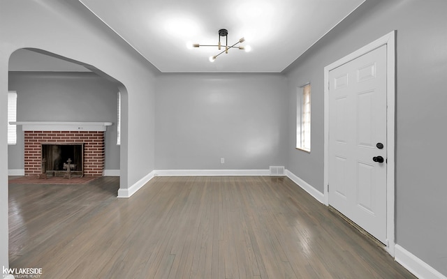 entrance foyer with dark wood-type flooring and a fireplace