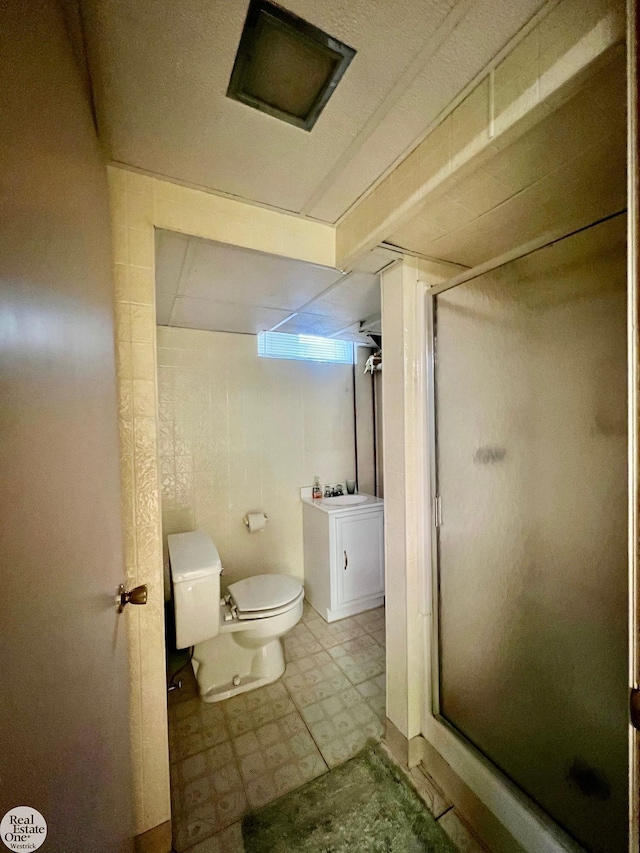 bathroom with toilet and walk in shower