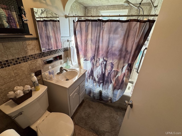 full bathroom featuring vanity, tile walls, shower / bath combination with curtain, and toilet