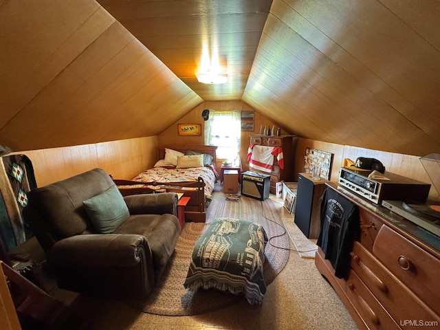 bedroom with lofted ceiling, wood ceiling, and wood walls