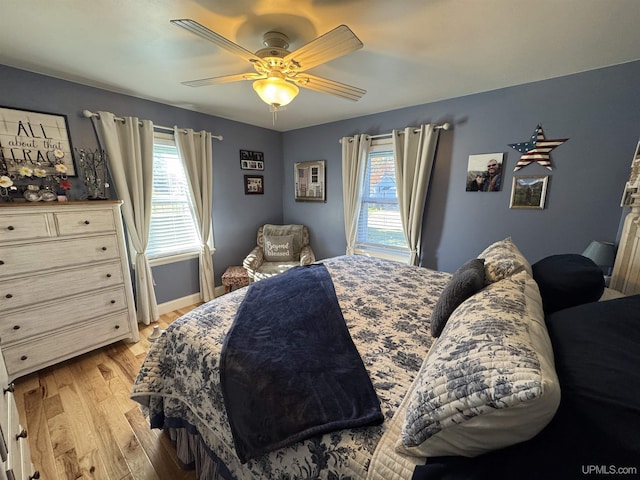 bedroom with ceiling fan and light hardwood / wood-style floors