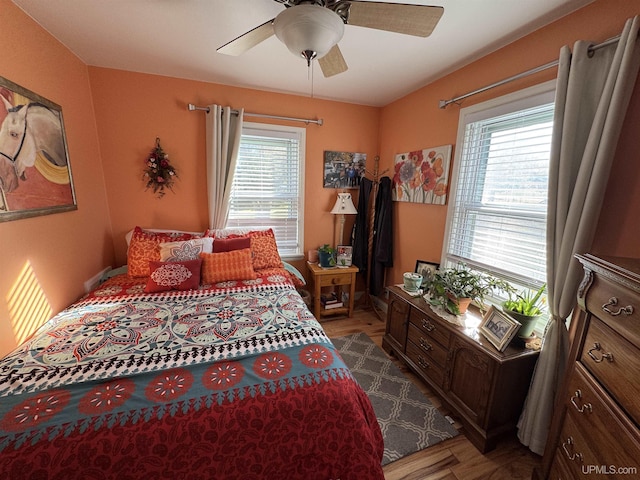 bedroom with ceiling fan and wood-type flooring