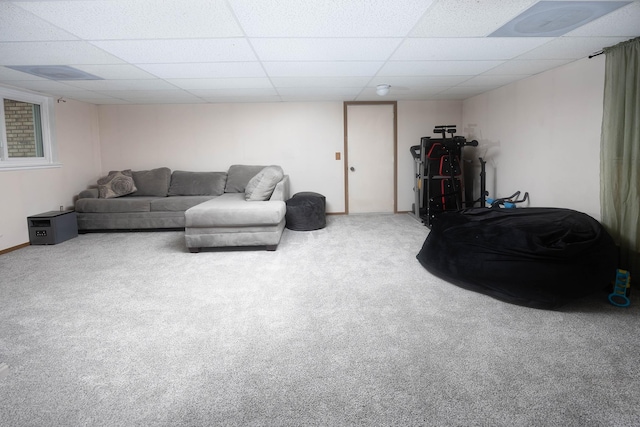 living room with a paneled ceiling and carpet flooring