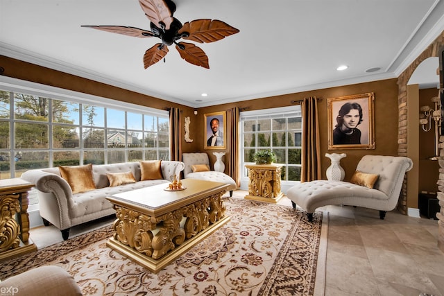 living room featuring crown molding and ceiling fan