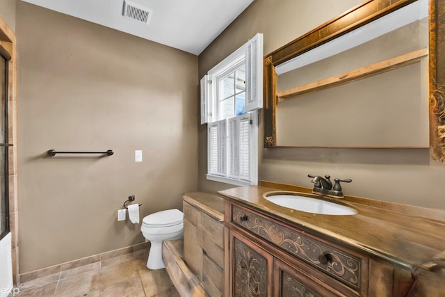 bathroom with vanity, tile patterned floors, and toilet