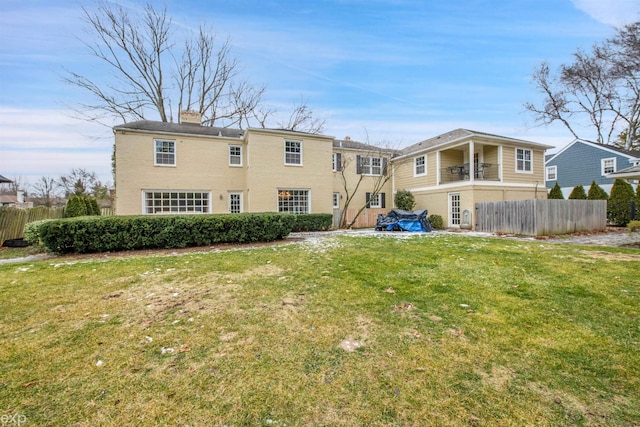 rear view of property with a yard