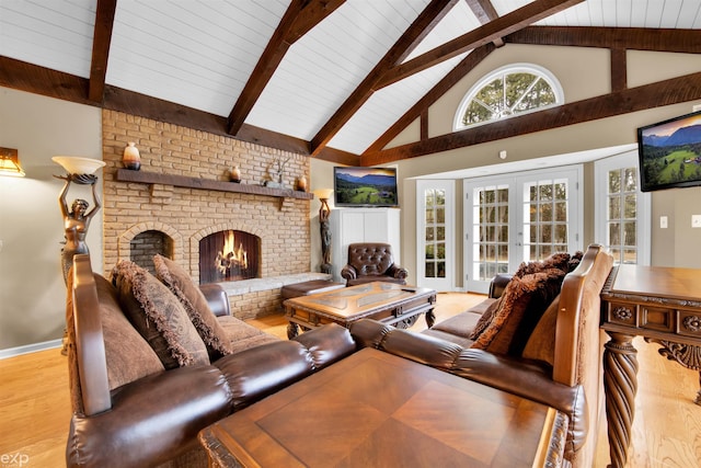 living room featuring high vaulted ceiling, light hardwood / wood-style floors, a brick fireplace, french doors, and beamed ceiling