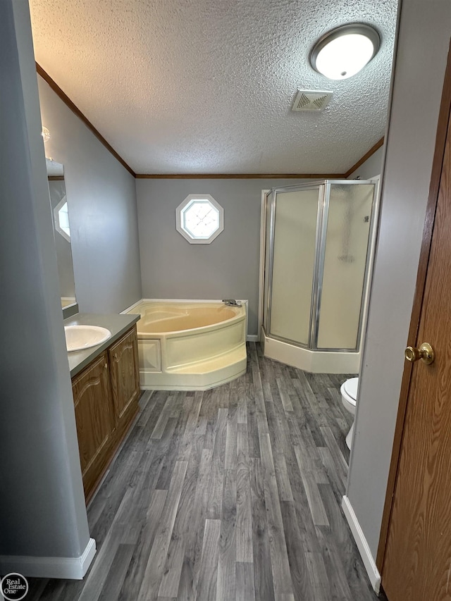 full bathroom featuring vanity, crown molding, wood-type flooring, and a textured ceiling