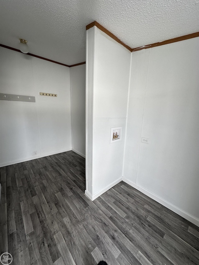 empty room featuring dark hardwood / wood-style flooring, crown molding, and a textured ceiling