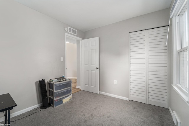 carpeted bedroom featuring a closet