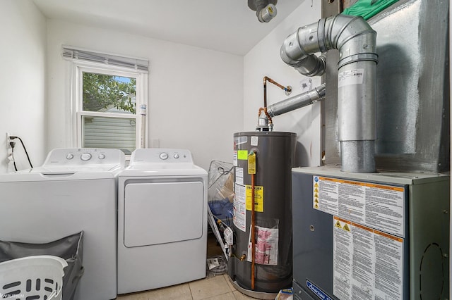 clothes washing area featuring water heater, separate washer and dryer, heating unit, and light tile patterned floors