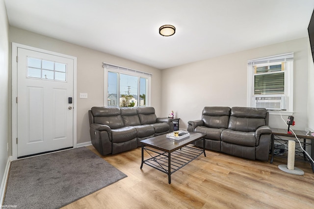 living room featuring cooling unit and light hardwood / wood-style floors