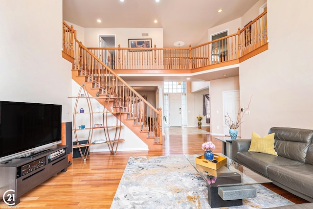 living room featuring hardwood / wood-style floors and a high ceiling