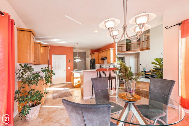 tiled dining area featuring a chandelier