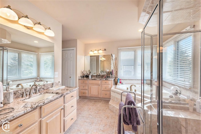 bathroom featuring tile patterned flooring, vanity, and shower with separate bathtub