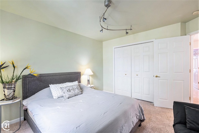 bedroom featuring rail lighting and a closet