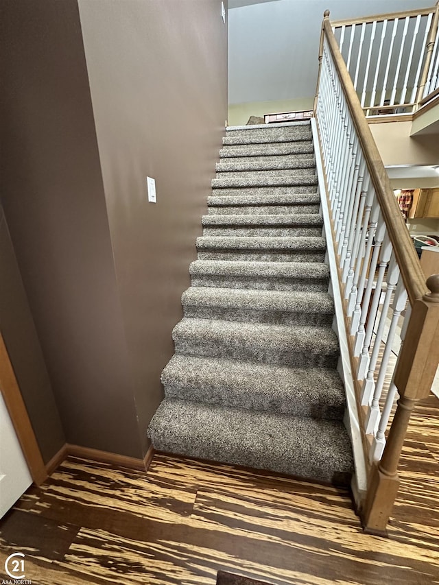 stairs with hardwood / wood-style floors