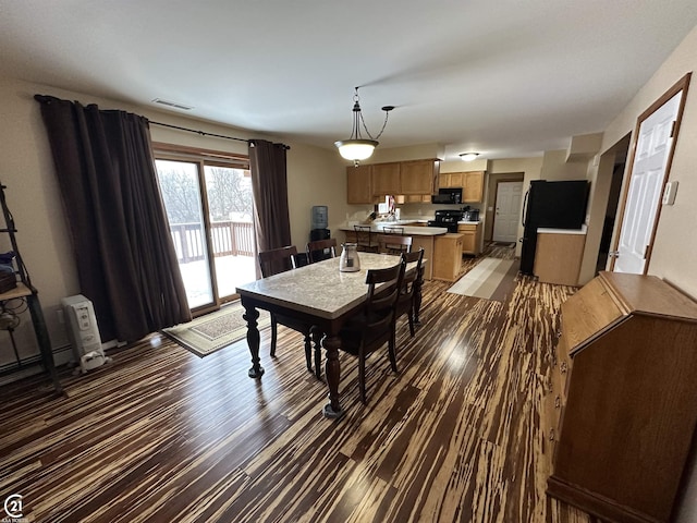 dining space with dark hardwood / wood-style floors