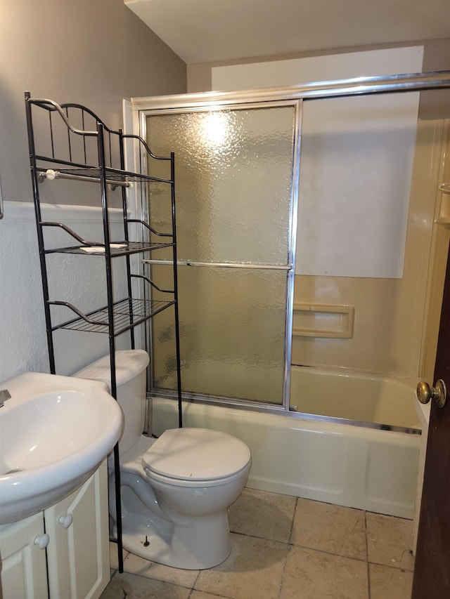 full bathroom featuring sink, toilet, and combined bath / shower with glass door