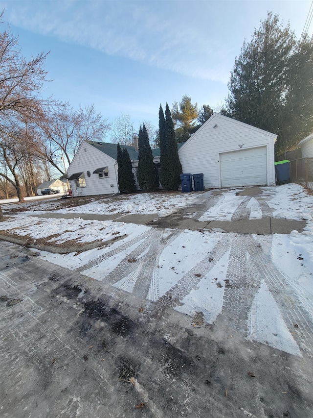 snow covered garage with cooling unit