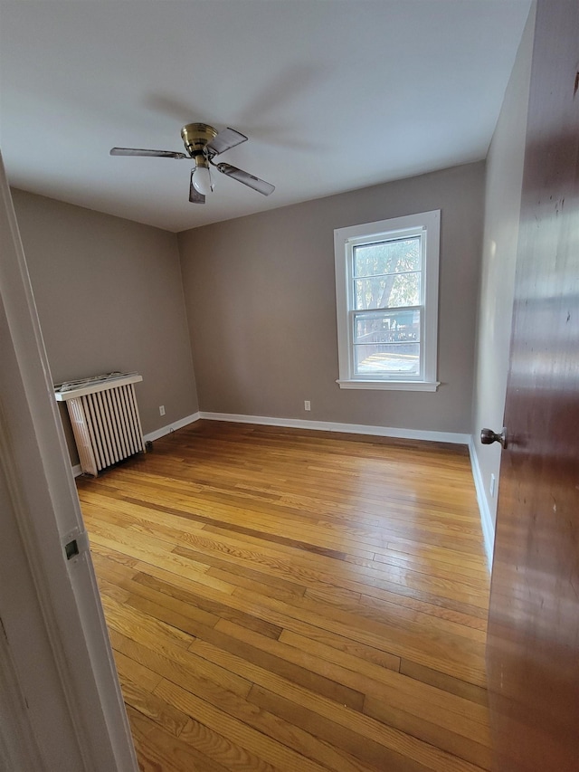 spare room with ceiling fan and light hardwood / wood-style floors