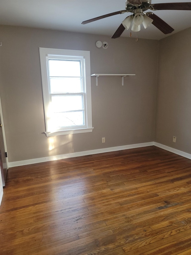 empty room featuring ceiling fan and dark hardwood / wood-style floors