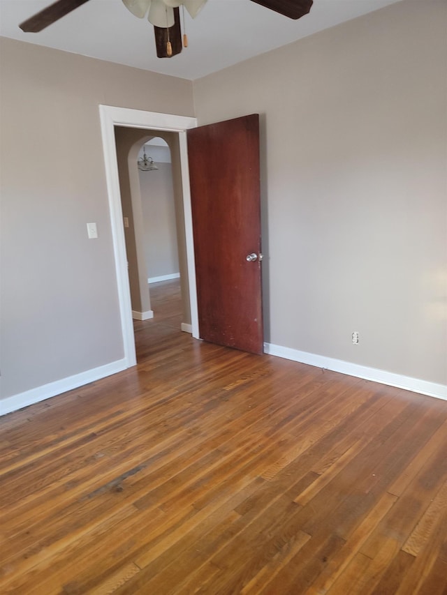 unfurnished room with dark hardwood / wood-style floors and ceiling fan