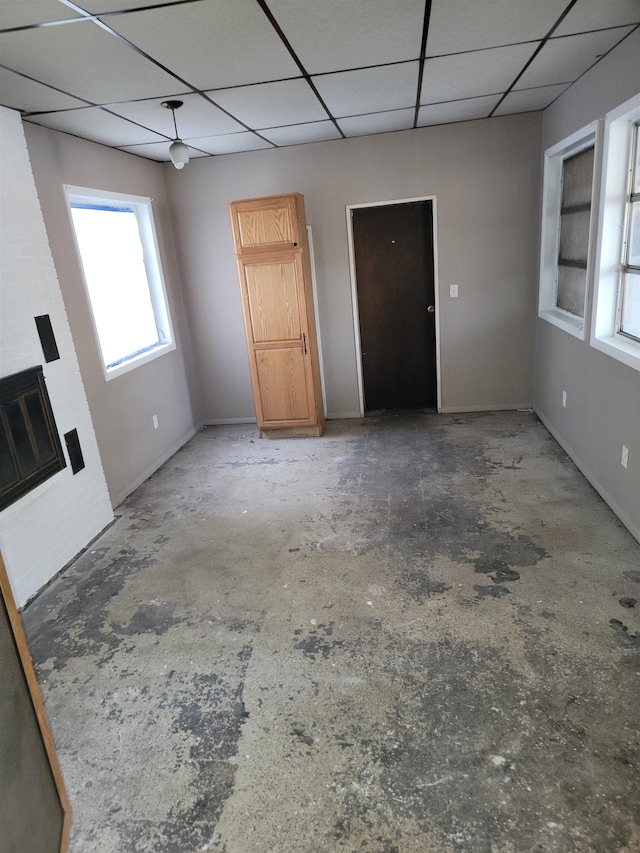 unfurnished living room with a drop ceiling