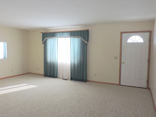 carpeted entryway with a healthy amount of sunlight