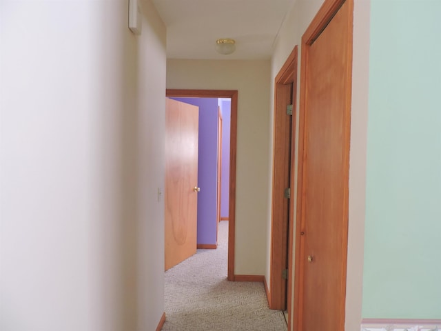 corridor featuring light colored carpet