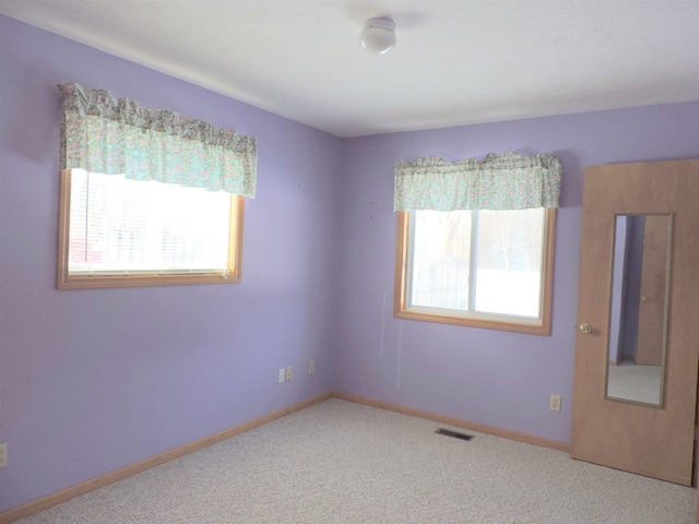 empty room featuring carpet flooring