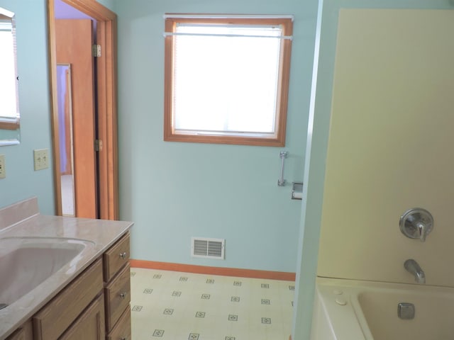 bathroom with vanity and shower / tub combination