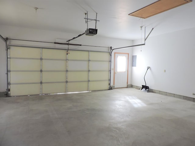 garage featuring a garage door opener and electric panel