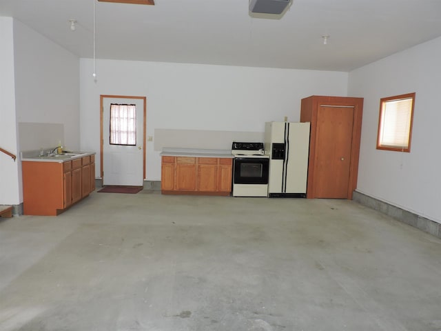 kitchen with electric stove, white refrigerator with ice dispenser, and sink