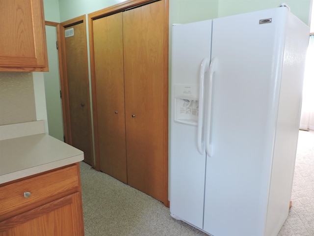 kitchen with white fridge with ice dispenser